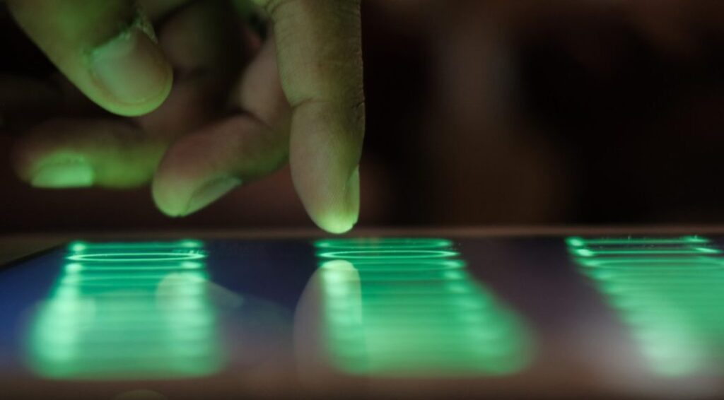 Finger about to tap a screen