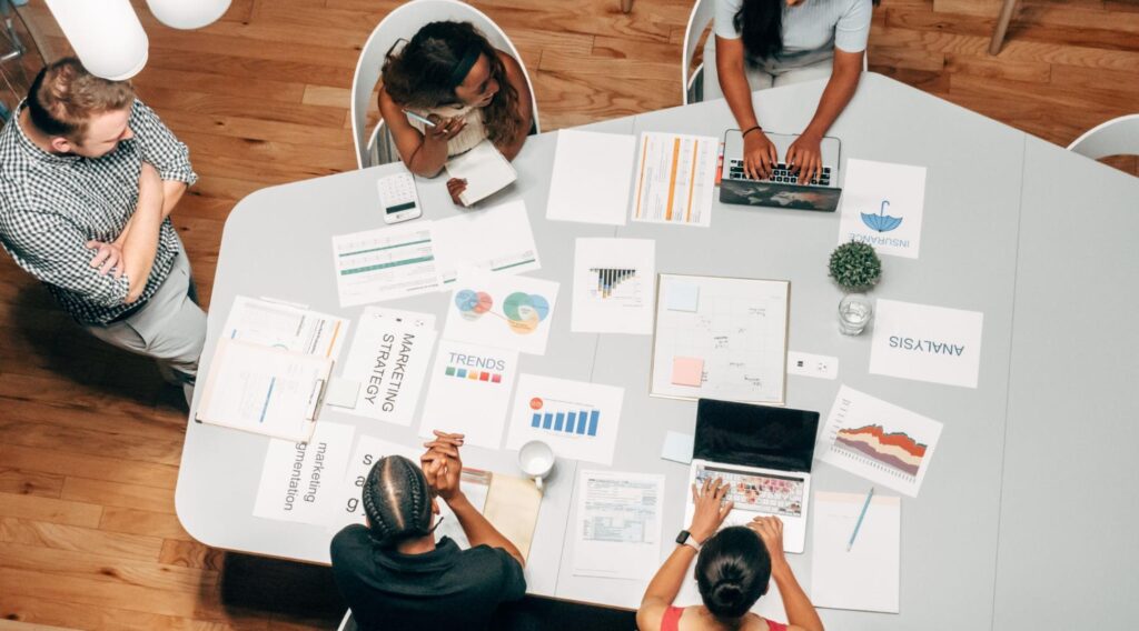 Birds eye view of a diverse team working together at a big table